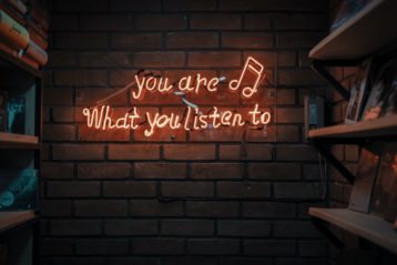 neon sign reading you are what you listen to