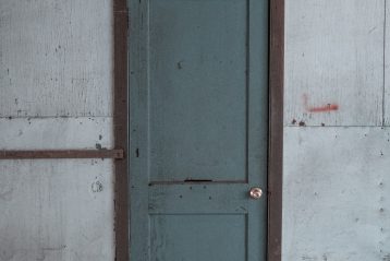 blue wooden door on white painted wall