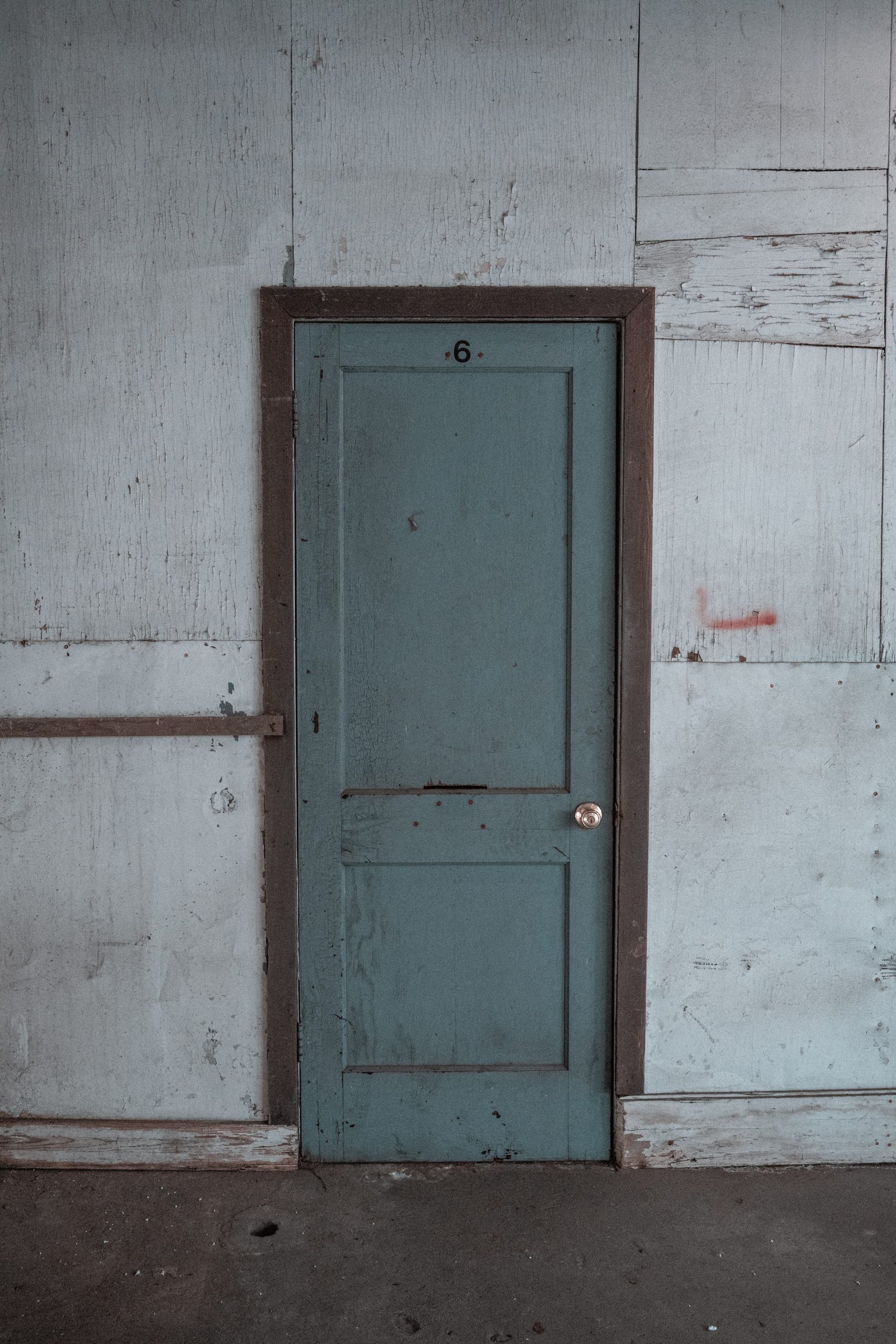 blue wooden door on white painted wall