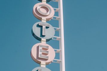 white and teal metal motel signage