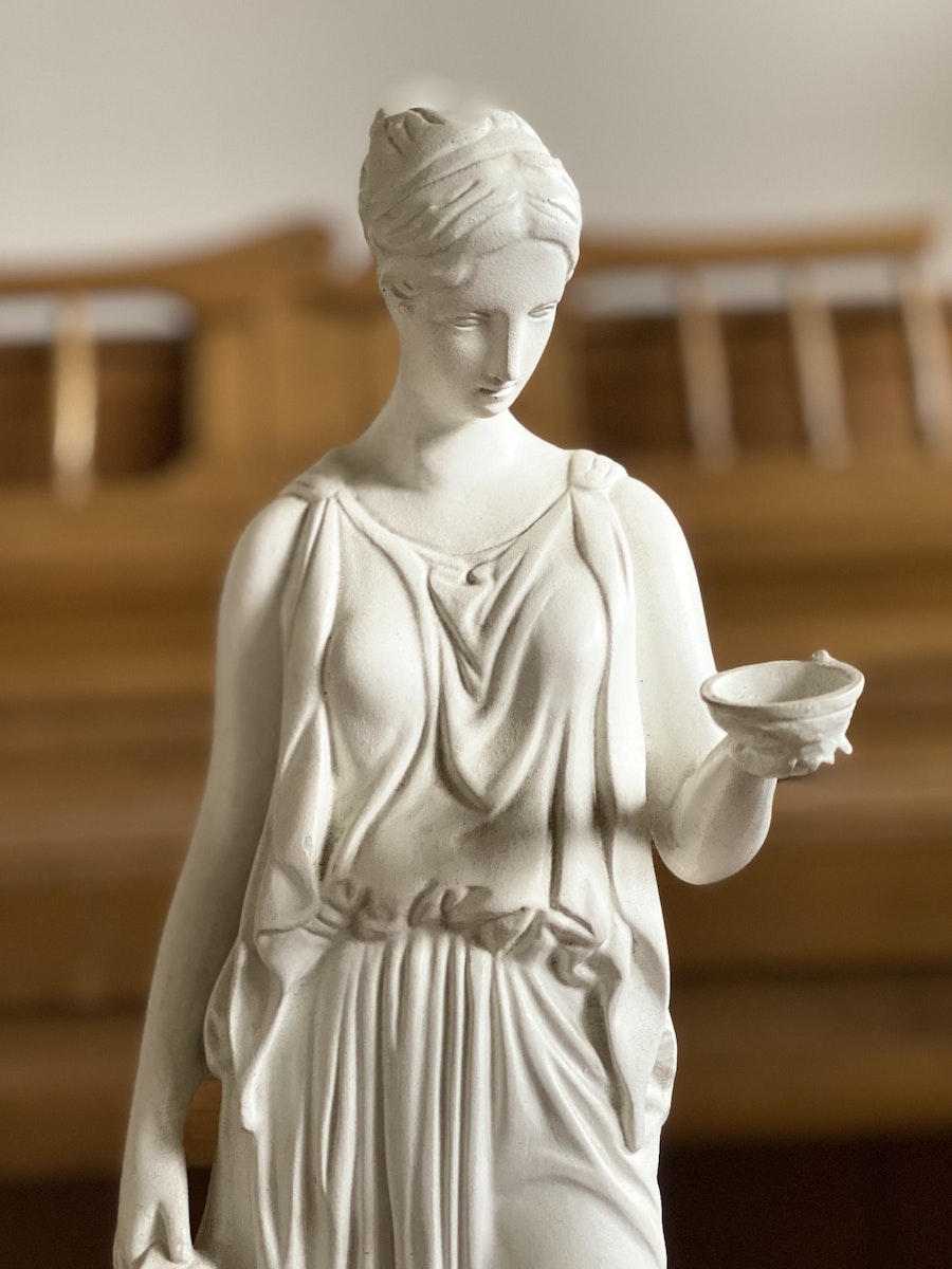 White Ceramic Statue Holding White Ceramic Teacup