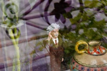 man in suit figurine in store window