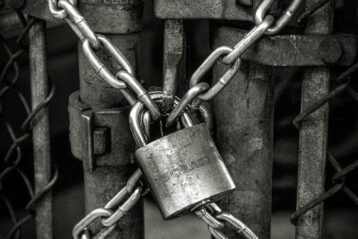 gray steel chain locked on gate