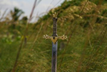 gray steel sword on ground during daytime