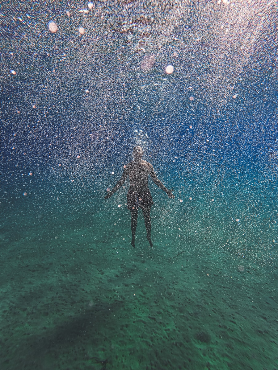 man in black shorts under water