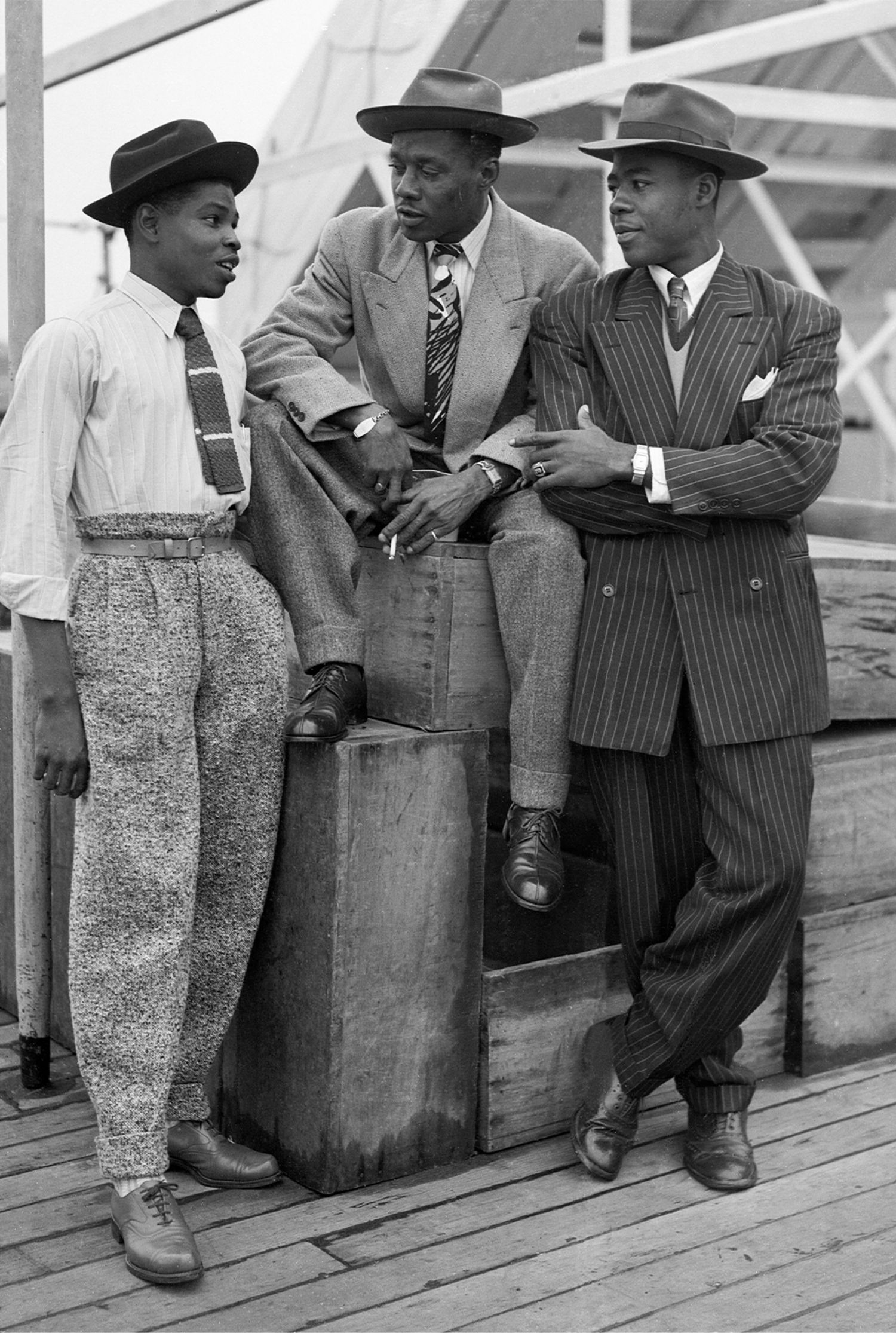 three fashionable Black men stand together