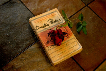 photo of a dorothy parker book with a rose on top