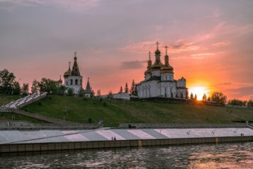 Skyline of Russian buildings under cloudy sky during sunset